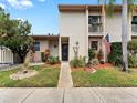 Charming townhouse featuring tidy landscaping, an American flag, and a cozy front porch area at 170 Ingrid Pl, Oldsmar, FL 34677