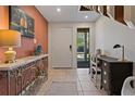 Inviting entrance hall with tiled floor, stylish console table, and modern decor at 357 8Th N Ave # 3, Tierra Verde, FL 33715