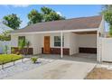 Inviting single-story home with a covered carport, manicured lawn, and brick accents at 439 E Boyer St, Tarpon Springs, FL 34689