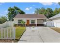 Charming single-story home featuring a cozy front porch and well-maintained landscaping at 439 E Boyer St, Tarpon Springs, FL 34689