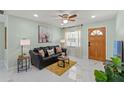 Cozy living room with a comfortable sofa, bright natural light, and a view of the front entrance at 439 E Boyer St, Tarpon Springs, FL 34689