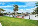 Waterfront property featuring a private wooden dock with bench for enjoying the scenic views and canal access at 5201 Dover Ne St, St Petersburg, FL 33703