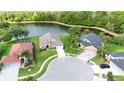 Residential neighborhood showcasing a single-story home with a well-kept lawn and pond views in the backyard at 5331 Villagebrook Dr, Wesley Chapel, FL 33544