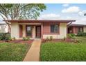 Attractive one-story home featuring tidy landscaping and a welcoming front entrance at 7501 Greystone Dr, Hudson, FL 34667