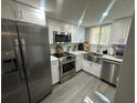Modern kitchen featuring stainless steel appliances and a stylish farmhouse sink at 9007 Pebble Creek Dr # 9007, Tampa, FL 33647