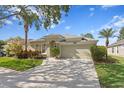 Charming single-story home with a well-manicured lawn and paver driveway at 10339 Lightner Bridge Dr, Tampa, FL 33626