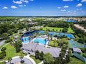 Beautiful aerial view of a community pool, tennis courts, and amenities surrounded by lush landscaping and homes at 14817 Tudor Chase Dr, Tampa, FL 33626
