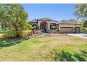 Charming home with manicured lawn and inviting entryway at 15810 Stanton Ln, Tampa, FL 33647