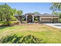 Beautiful home featuring manicured landscaping and a grand entrance at 15810 Stanton Ln, Tampa, FL 33647