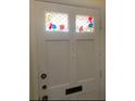 Close-up view of the white front door featuring leaded glass inserts at 1679 S Lake Ave # 4, Clearwater, FL 33756