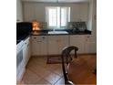 Bright kitchen with white cabinets, updated appliances, and tile flooring at 1679 S Lake Ave # 4, Clearwater, FL 33756