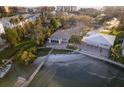 Aerial view of waterfront property with a dock, lush landscaping, and views of the bay at 175 Bath Club N Blvd, North Redington Beach, FL 33708