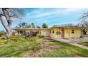 Single story home showcasing a lush lawn, beautiful garden, and a welcoming entrance at 175 Bath Club N Blvd, North Redington Beach, FL 33708