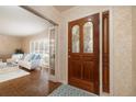 Elegant entrance hall with hardwood flooring, complemented by a stained wood door with decorative glass inserts at 1874 Cameo Way, Clearwater, FL 33756