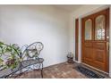 Inviting front entry with brick flooring, butterfly bench and decorative front door at 1874 Cameo Way, Clearwater, FL 33756