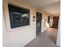 A welcoming entrance featuring a stylish black front door and a window with blinds at 2306 Hammock Pine Blvd # 2306, Clearwater, FL 33761