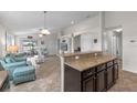 Open concept kitchen and living room, with tile floors and neutral walls at 2404 Dovesong Trace Dr, Ruskin, FL 33570
