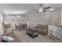 Inviting living room featuring tile floors, a ceiling fan, and neutral paint, creating a bright and airy atmosphere at 2404 Dovesong Trace Dr, Ruskin, FL 33570