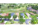 Aerial view of neighborhood homes nestled around a lush golf course, creating a serene community setting at 2816 Graphite Ct, Valrico, FL 33594