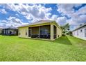 Spacious backyard features a screened-in lanai for enjoying the outdoors with view of well-manicured lawn at 2816 Graphite Ct, Valrico, FL 33594