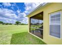 View of screened-in patio overlooking the lush green golf course on a bright, partly cloudy day at 2816 Graphite Ct, Valrico, FL 33594