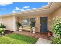 Inviting front porch with a bench, plants, and a decorated front door at 3360 Masters Dr, Clearwater, FL 33761