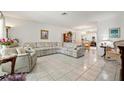 Bright living room featuring tile floors and an open layout to the dining area at 3360 Masters Dr, Clearwater, FL 33761