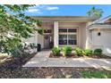 Charming front entrance with decorative wreath, large windows, and lush landscaping at 3505 Kilmer Dr, Plant City, FL 33566