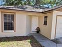 Inviting one-story home featuring a manicured lawn, covered porch and white front door at 3625 Simcoe Ct, Palm Harbor, FL 34684