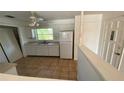 Bright, tiled kitchen featuring white appliances, ample counter space, and natural light at 4518 Narraganset Trl # 85A, Sarasota, FL 34233