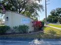 Community entrance sign for Lake Tippecanoe, with lush landscaping and a sidewalk at 4518 Narraganset Trl # 85A, Sarasota, FL 34233