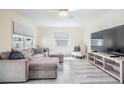 Spacious living area with large windows, comfortable seating, and modern wood-look floors at 4568 67Th N St, St Petersburg, FL 33709