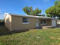 Charming single-story home with a well-manicured lawn and a cozy front porch at 5130 Tilson Dr, New Port Richey, FL 34652