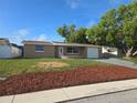 Inviting single-story home featuring a well-maintained lawn and fresh landscaping at 5130 Tilson Dr, New Port Richey, FL 34652
