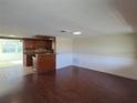 Spacious living room with hardwood floors, flowing into an open-concept kitchen at 5130 Tilson Dr, New Port Richey, FL 34652