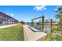 Wide dock equipped with a boat lift provides direct access to the serene waterway at 6511 Senegal Palm Way, Apollo Beach, FL 33572