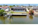 Waterfront home with a screened lanai, pool, and a private boat dock at 6511 Senegal Palm Way, Apollo Beach, FL 33572