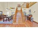 Grand foyer showcases a beautiful staircase, hardwood floors, and views of the dining room and living spaces at 7591 Harbor View Way, Seminole, FL 33776