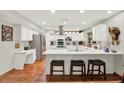 Bright kitchen featuring a large island with seating, modern stainless steel appliances, and ample storage at 7591 Harbor View Way, Seminole, FL 33776