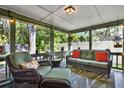 Cozy covered patio featuring comfortable wicker seating and a peaceful outdoor view at 7591 Harbor View Way, Seminole, FL 33776