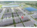 Beautiful aerial view of townhomes near a lake providing community charm at 8299 Crescent Oaks Dr, New Port Richey, FL 34655