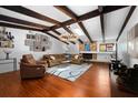 Spacious living room boasts wood floors, vaulted ceilings, and a stone fireplace at 838 Park Ct, Palm Harbor, FL 34683