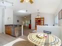 Open-concept kitchen with stainless steel appliances, granite counters, and views of the living area at 9608 Rolling Cir, San Antonio, FL 33576
