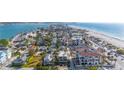 Expansive aerial view showcasing beach homes and the shimmering coastline in a vibrant seaside community at 108 14Th Ave # 2, St Pete Beach, FL 33706