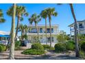 Inviting two-story home with balconies, nestled among palm trees and lush greenery for a tropical paradise at 108 14Th Ave # 2, St Pete Beach, FL 33706