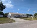Well-maintained single-story house with a driveway, garage, and a green lawn in a quiet neighborhood at 10968 105Th Ave, Largo, FL 33778
