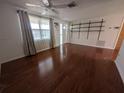 The spacious living room features hardwood floors, a ceiling fan, and bright natural light at 10968 105Th Ave, Largo, FL 33778