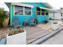 Inviting front porch area with cozy seating and decorative potted plants, perfect for relaxing outdoors at 11 Lafayette St, Bradenton, FL 34208