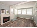 Bright living room featuring new floors, fireplace, and lots of windows allowing for ample natural light at 11 Lafayette St, Bradenton, FL 34208