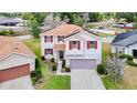Aerial view of home featuring a separate garage, solar panels, and a landscaped yard at 1105 Canyon Oaks Dr, Brandon, FL 33510